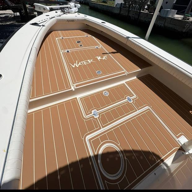 Bow deck on a centre console, teak-look planking with the boat name inlaid