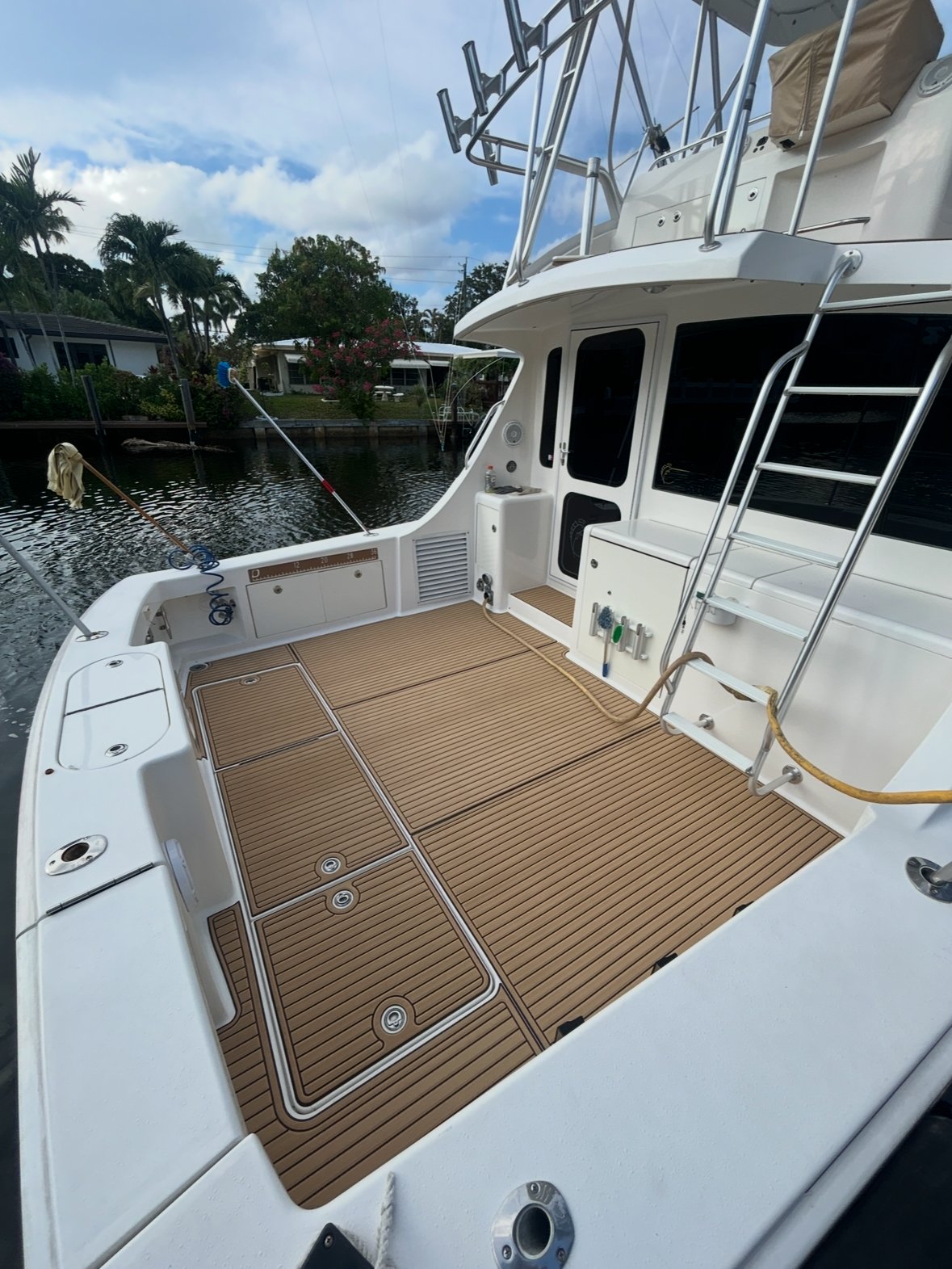 Aft deck on a sportfish yacht, tan planking with white seams