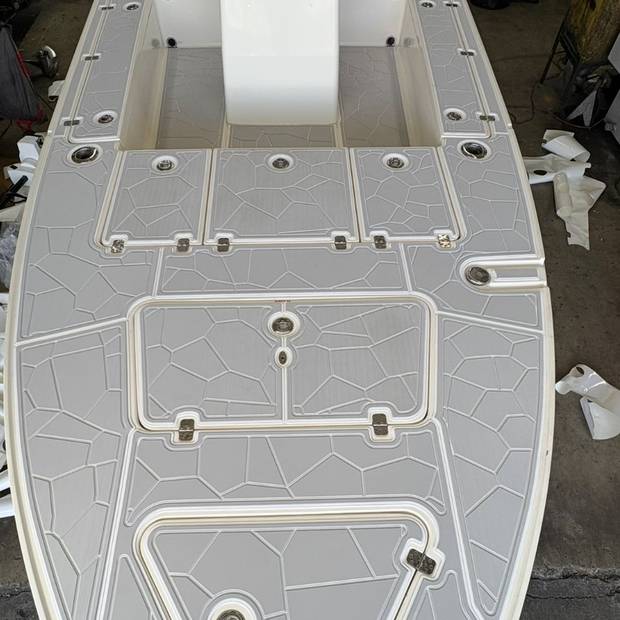 Full deck on a flats boat, gray with a shattered-stone pattern and white seams