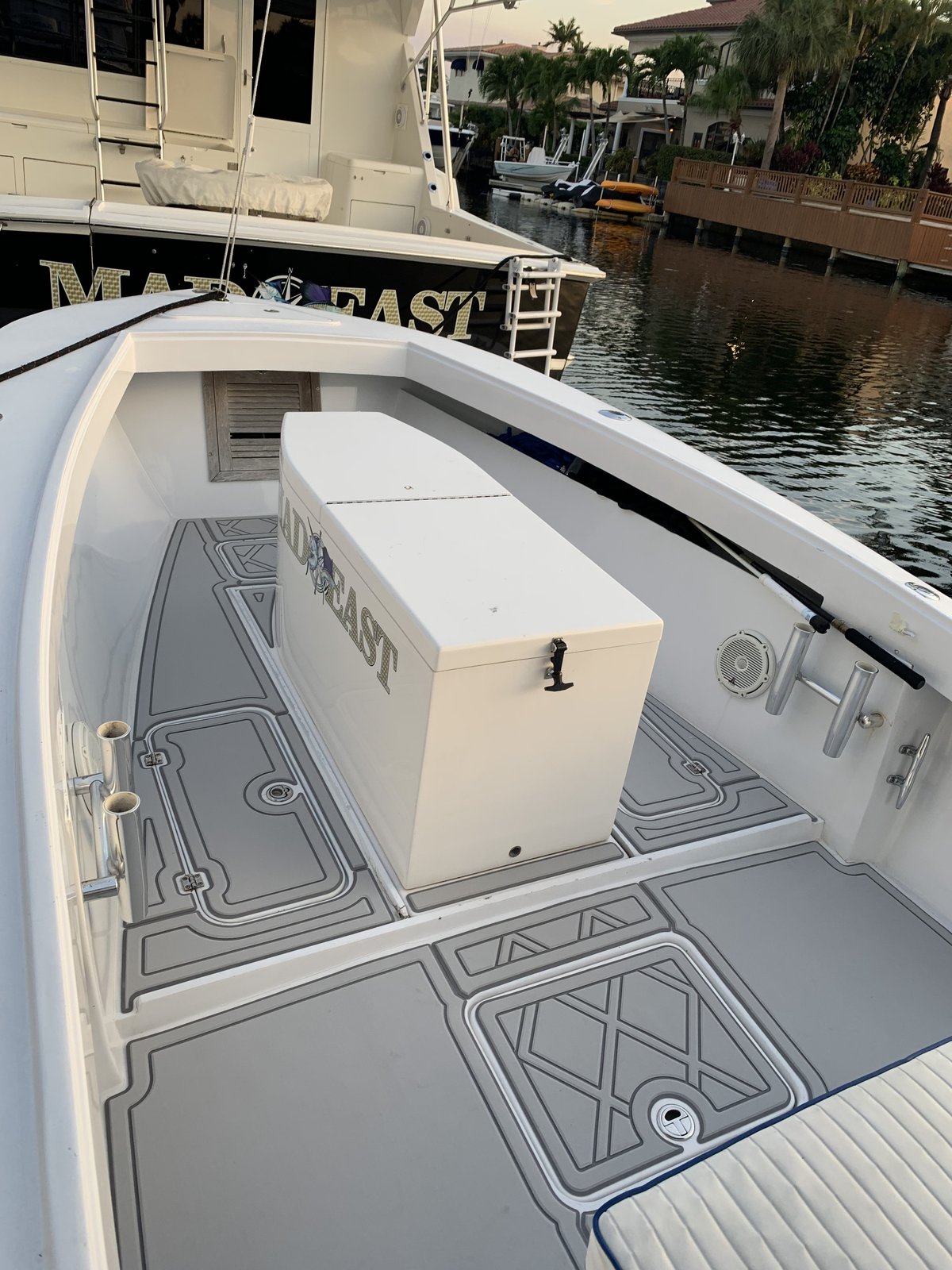Bow storage box and cockpit sole on a sportfish named Mad East, gray planking with white seams